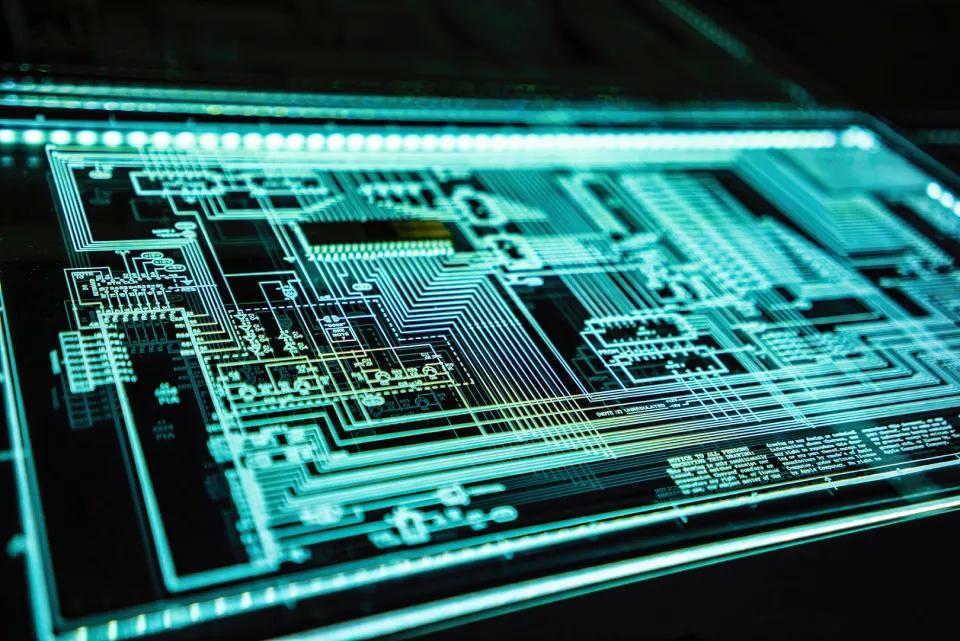 Complex digital circuit board illuminated in green.