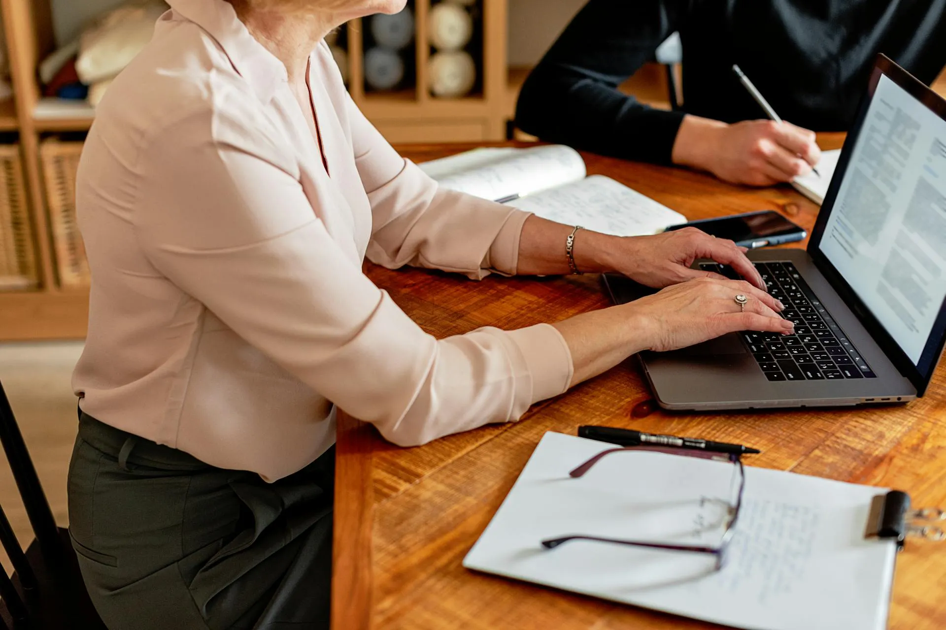 Two people working together on laptops